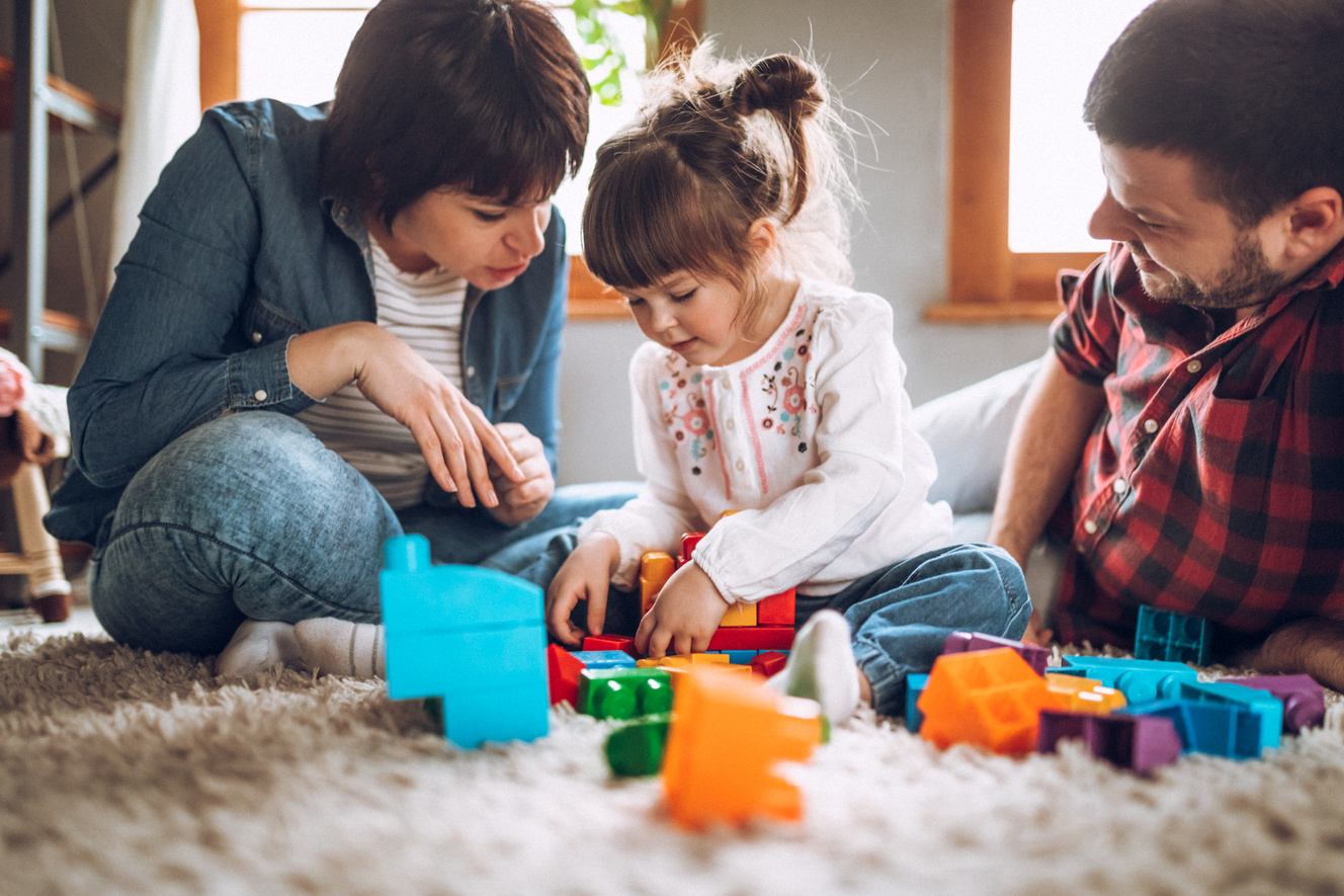 Sweet child playing with parents